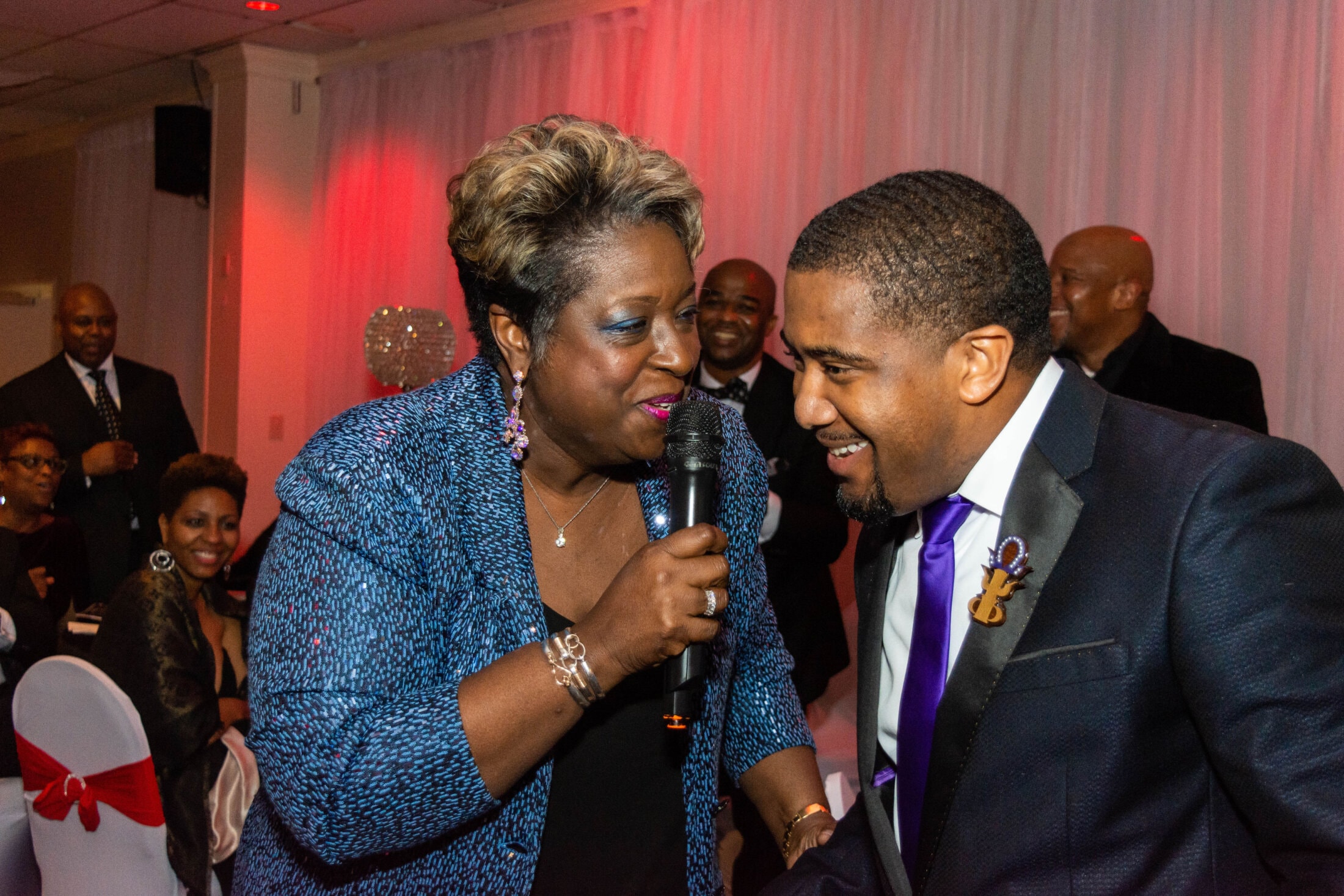 Live performer with microphone at Black and White Scholarship Gala