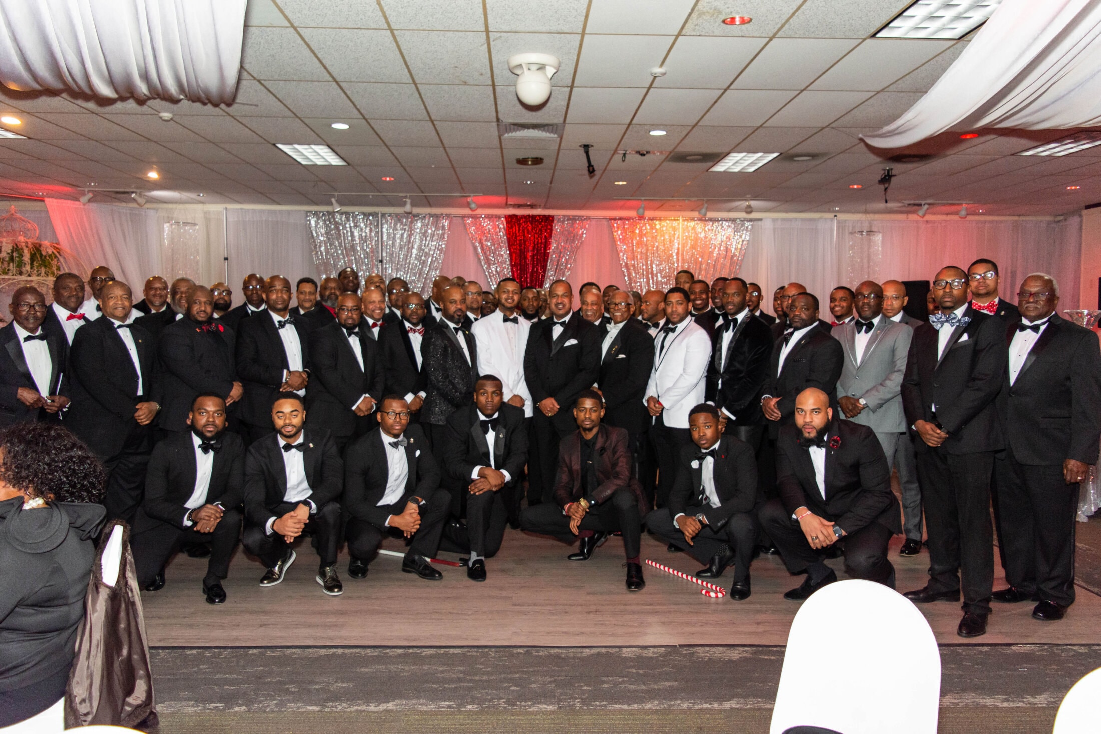 Large chapter group photo in tuxedos at the Scholarship Gala