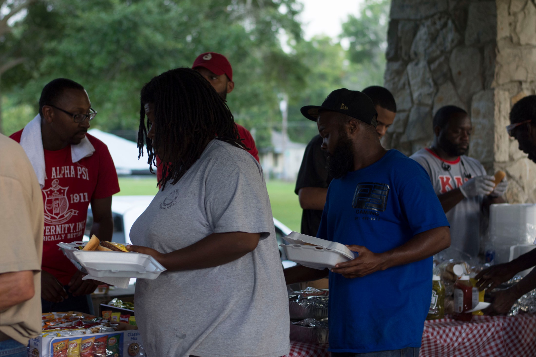 Brothers and community members at outdoor food service table