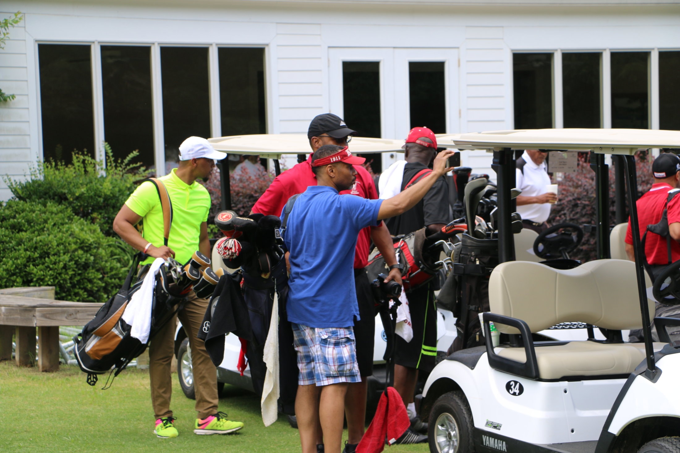Brothers loading golf bags onto carts at the Golf Klassic