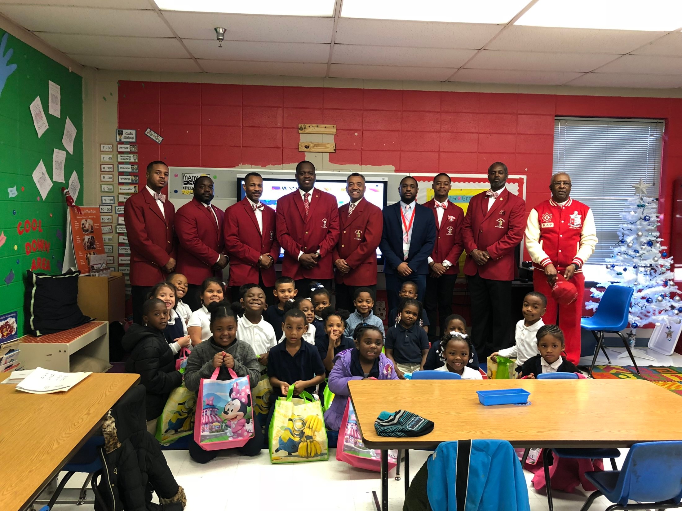 Brothers with elementary school children at Christmas gift drive