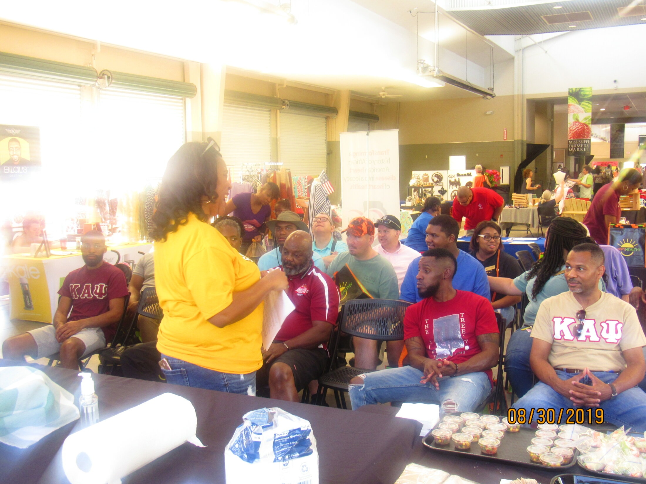 Brothers and community members at Mississippi Farmers Market health event