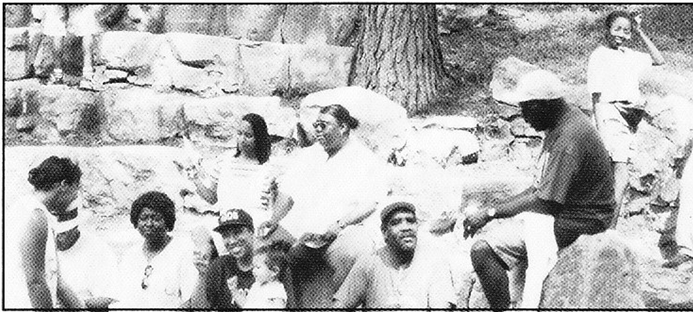 Brothers in casual outdoor group photo near stone wall